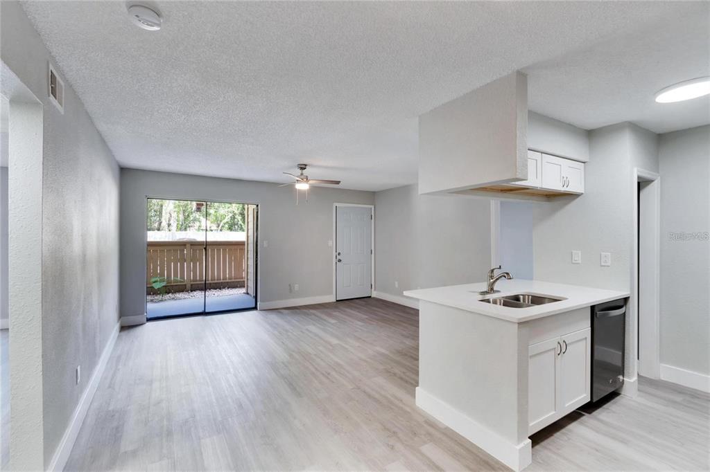 8718 Mallard Reserve Drive, Unit 101 Tampa, FL 33614 - Photo 8 of 25 a kitchen that has a sink a stove and a wooden floor
