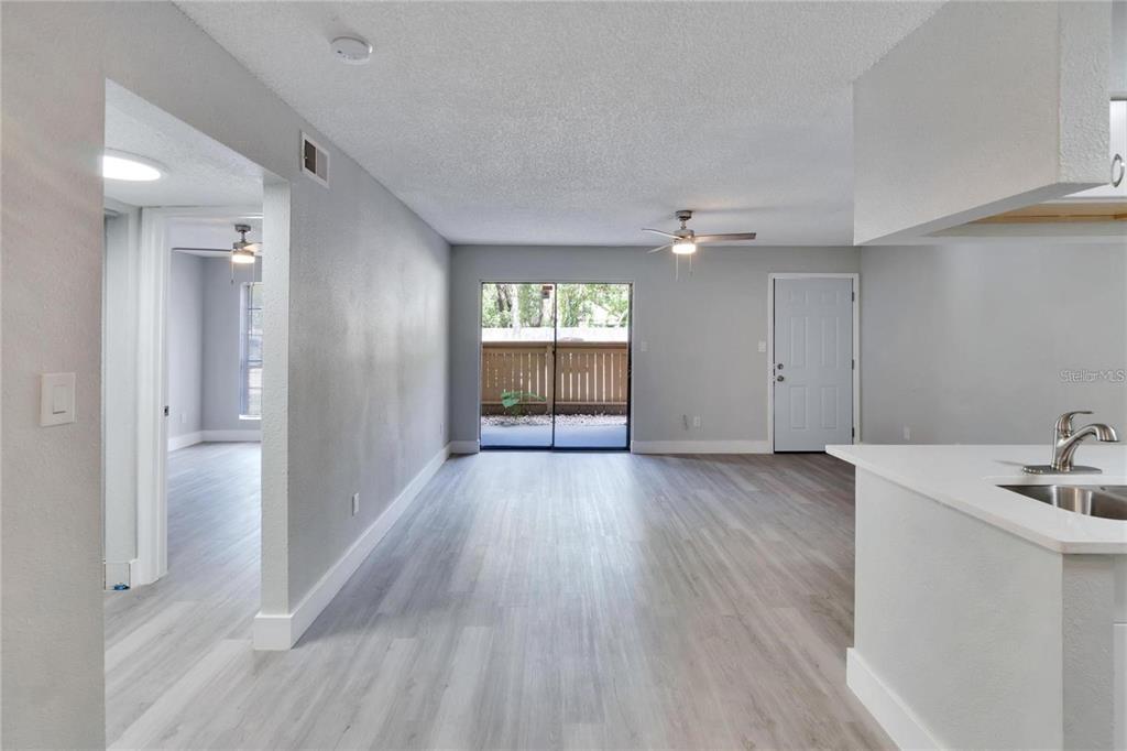 8718 Mallard Reserve Drive, Unit 101 Tampa, FL 33614 - Photo 9 of 25 wooden floor in an empty room with a window