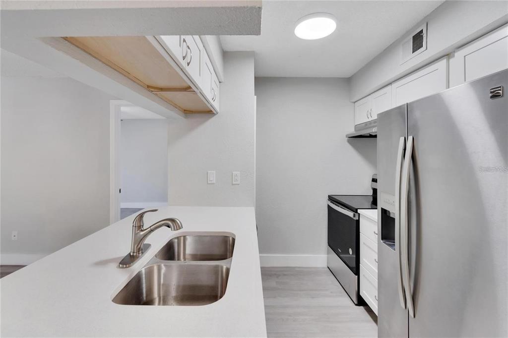 8718 Mallard Reserve Drive, Unit 101 Tampa, FL 33614 - Photo 10 of 25 a bathroom with a sink a toilet and shower