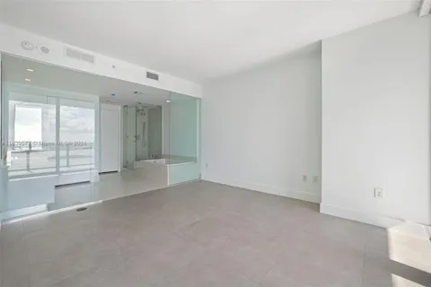a bathroom with a double vanity sink mirror and shower