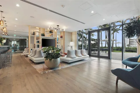 a living room with fireplace furniture and a potted plant