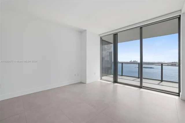 a view of an empty room with glass door