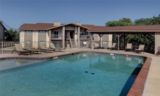 a view of a house with swimming pool and porch