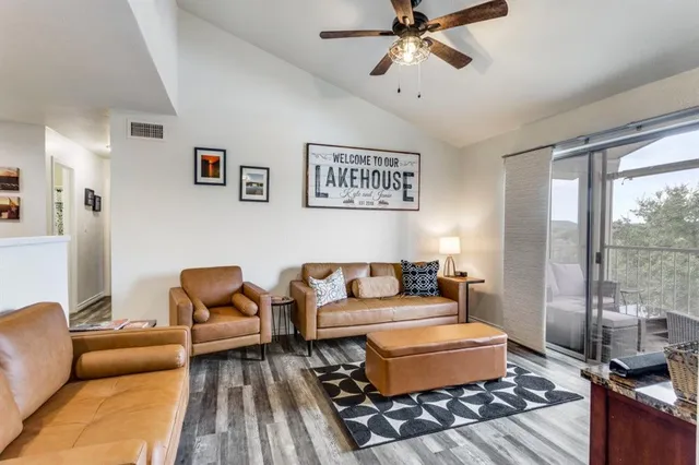 a living room with furniture a ceiling fan and a rug