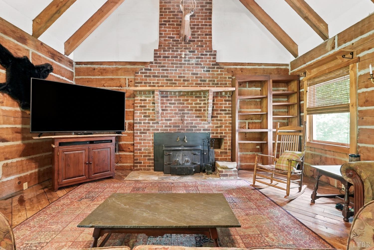 Undisclosed Address Spout Spring, VA 24593 - Photo 20 of 96 a living room with fireplace furniture and a flat screen tv