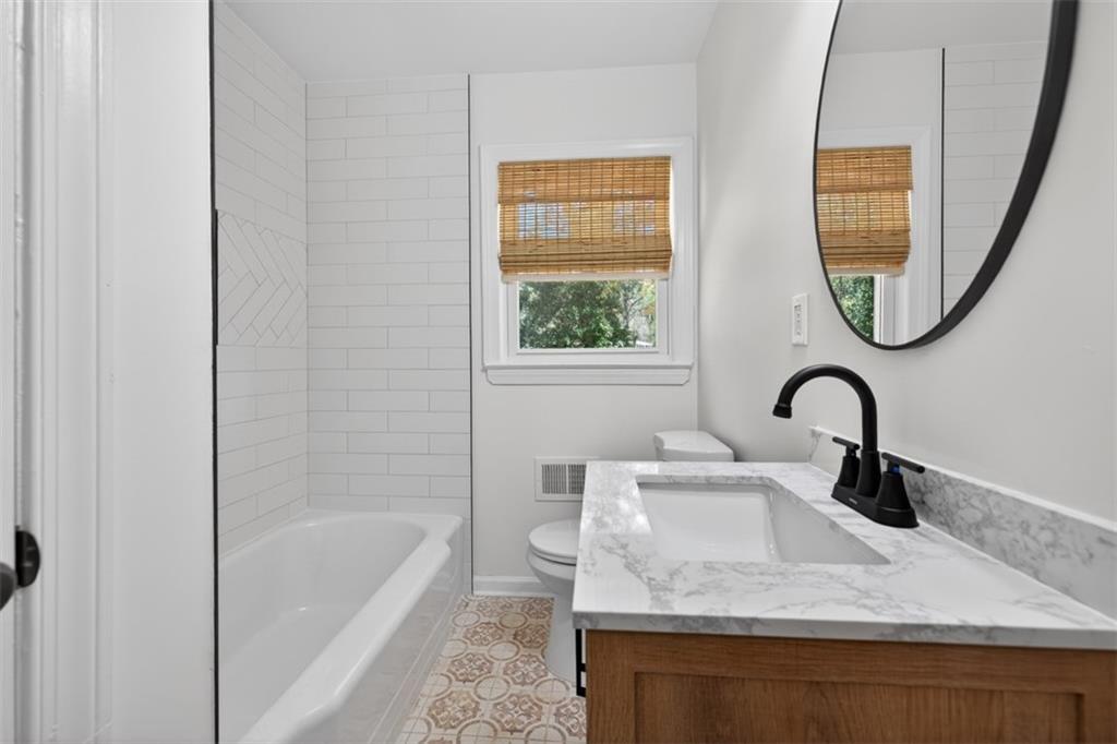 3061 Glendale Court Decatur, GA 30032 - Photo 17 of 21 a bathroom with a sink a bathtub and a window