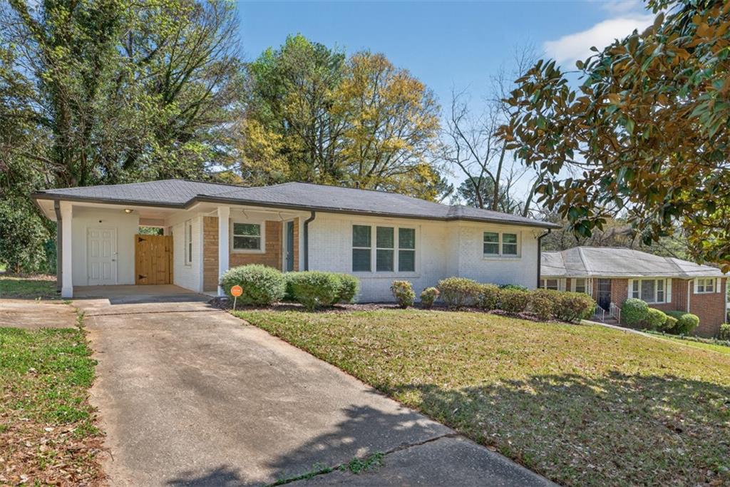 3061 Glendale Court Decatur, GA 30032 - Photo 2 of 21 a front view of a house with a garden and yard