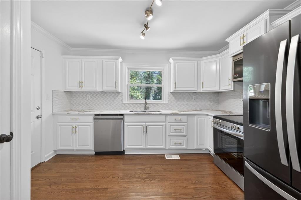 3061 Glendale Court Decatur, GA 30032 - Photo 8 of 21 a kitchen with stainless steel appliances granite countertop a stove a sink and a refrigerator
