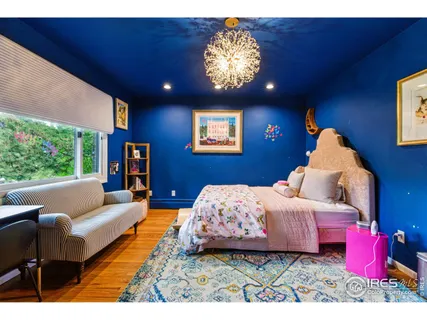 a bedroom with furniture and a large window