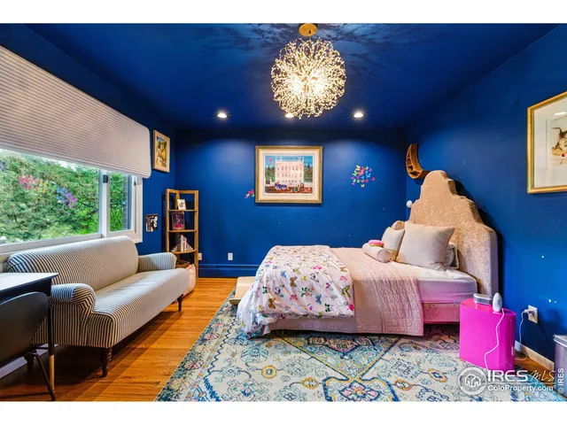 a bedroom with furniture and a large window