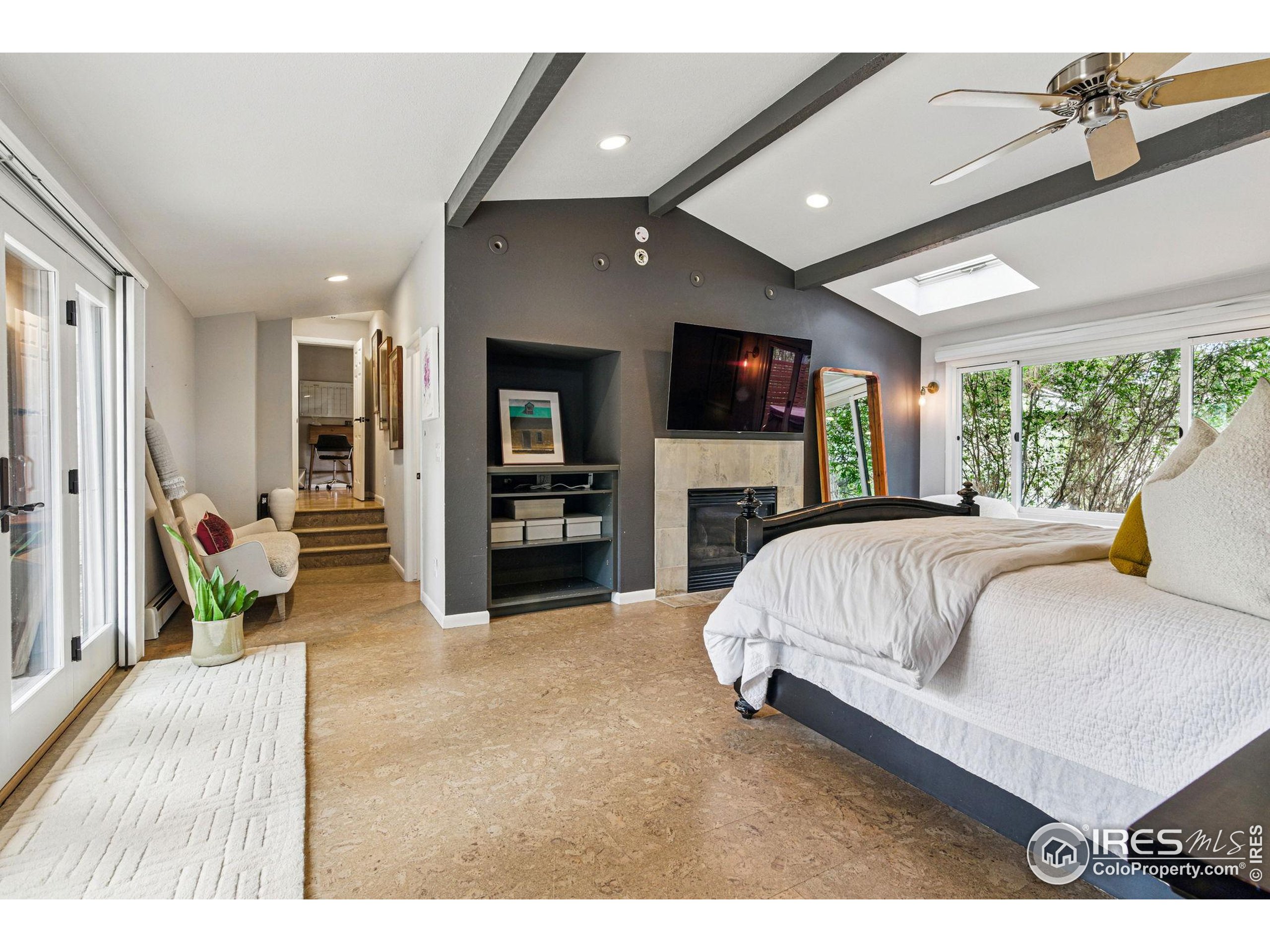 182 Ridge Road Boulder, CO 80303 - Photo 29 of 43 a spacious bedroom with a large bed and a flat screen tv