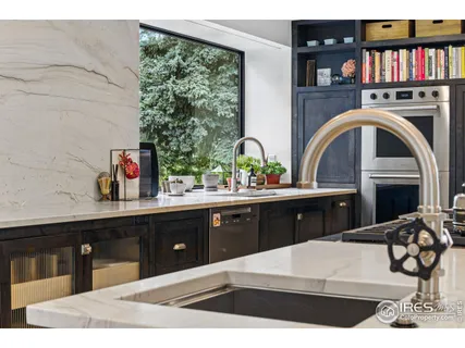 a kitchen with stainless steel appliances kitchen island granite countertop a stove a sink and a microwave