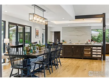 a living room with lots of furniture and a large mirror
