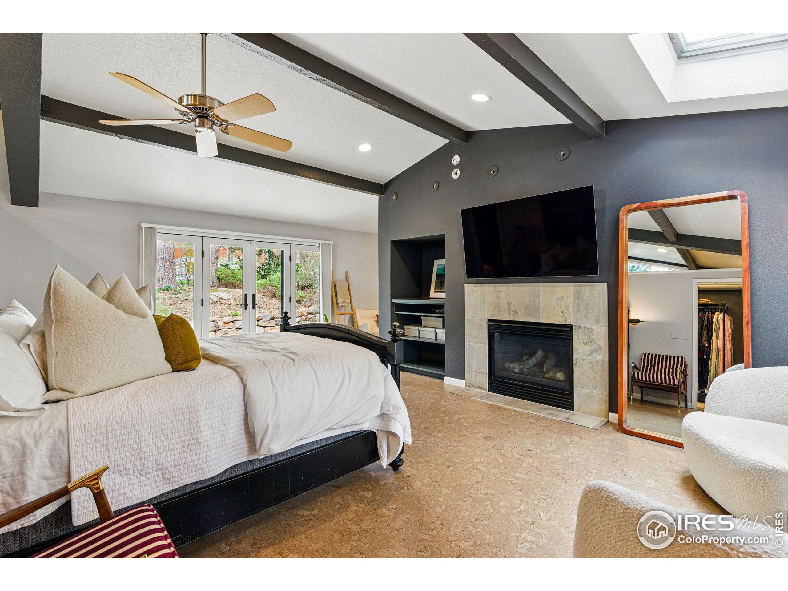 182 Ridge Road Boulder, CO 80303 - Photo 4 of 43 a spacious bedroom with a bed and a flat screen tv