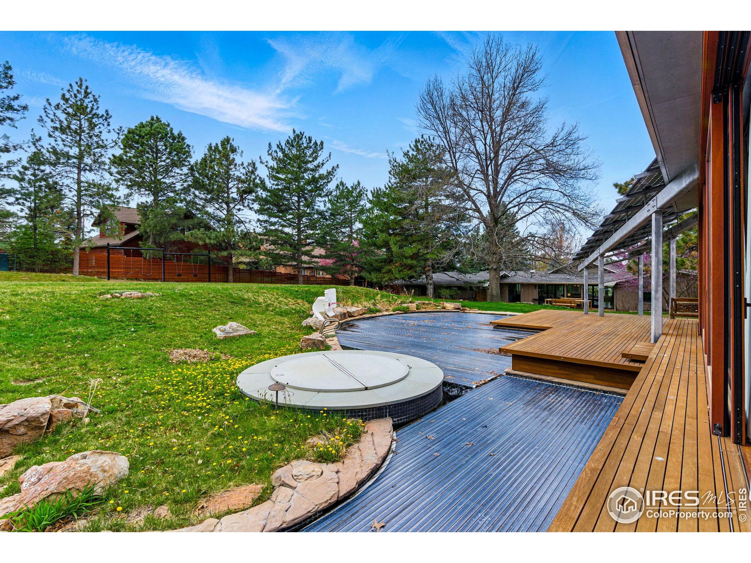 182 Ridge Road Boulder, CO 80303 - Photo 10 of 43 a backyard of a house with table and chairs
