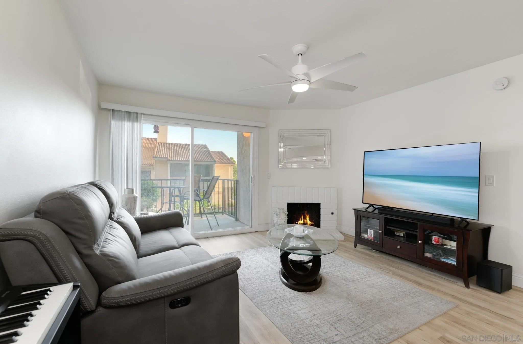 a living room with furniture a fireplace and a flat screen tv