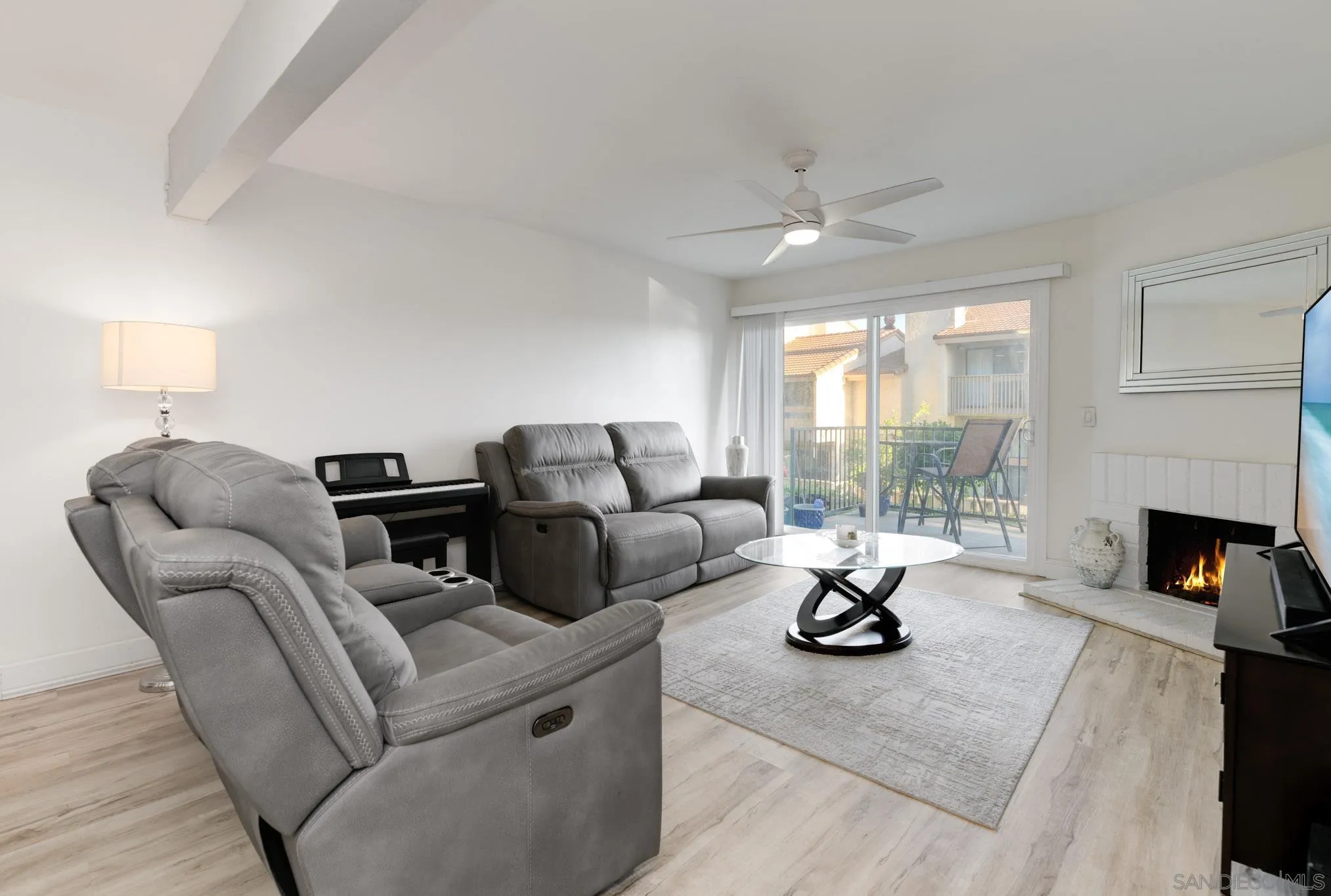 6877 Caminito Mundo, Unit 25 San Diego, CA 92119 - Photo 11 of 28 a living room with furniture and a fireplace