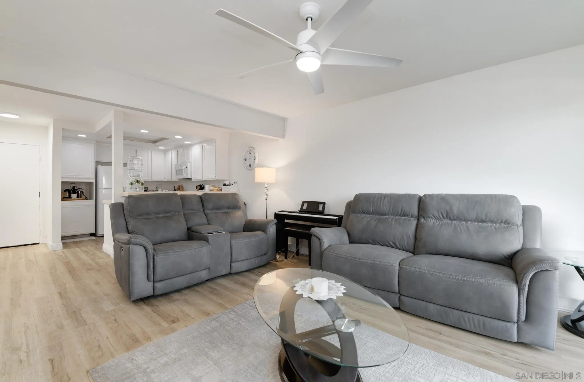 6877 Caminito Mundo, Unit 25 San Diego, CA 92119 - Photo 16 of 28 a living room with furniture and a dining table with kitchen view