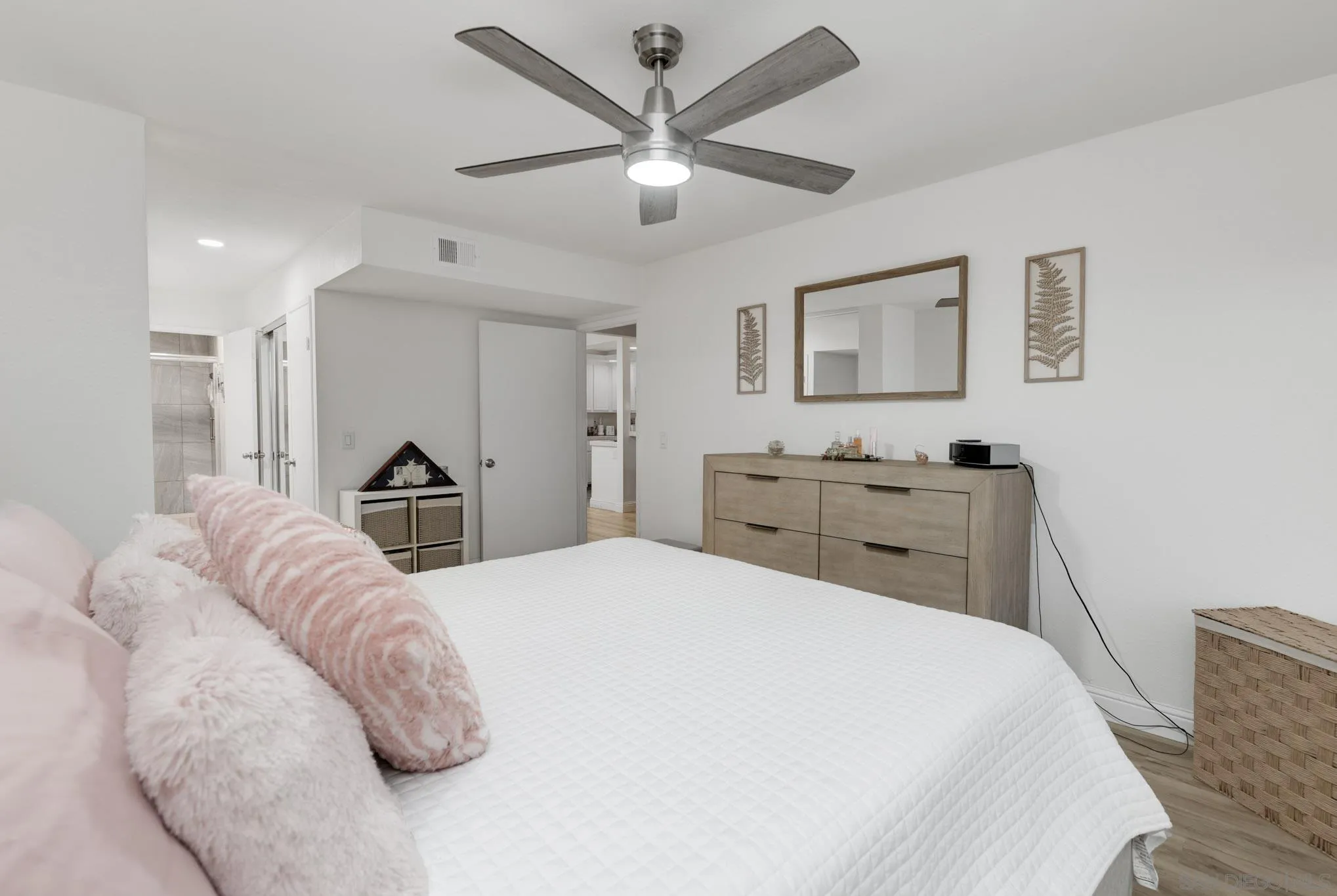 6877 Caminito Mundo, Unit 25 San Diego, CA 92119 - Photo 17 of 28 a bedroom with a bed and a dresser with the potted plant