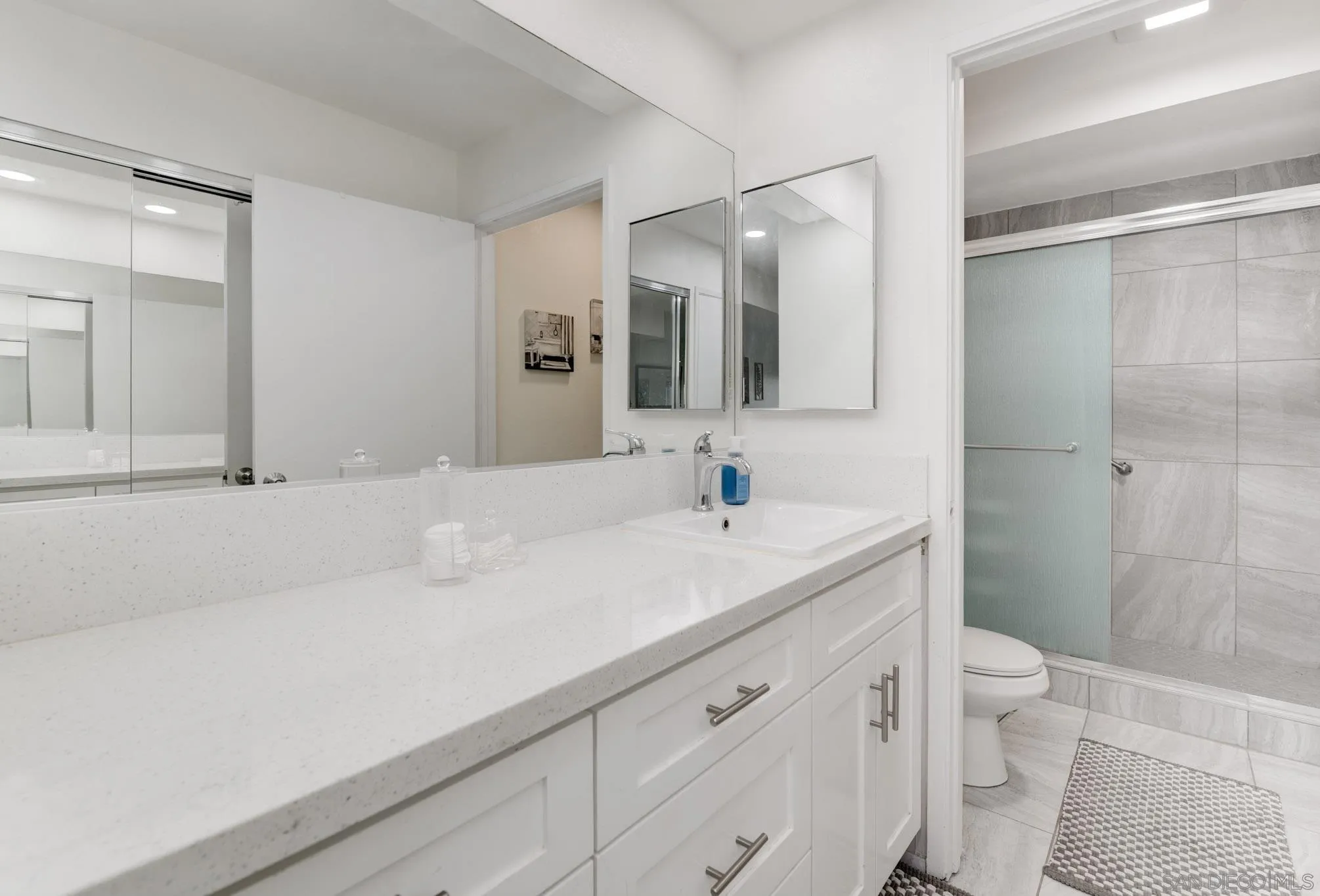 6877 Caminito Mundo, Unit 25 San Diego, CA 92119 - Photo 20 of 28 a bathroom with a sink and a mirror