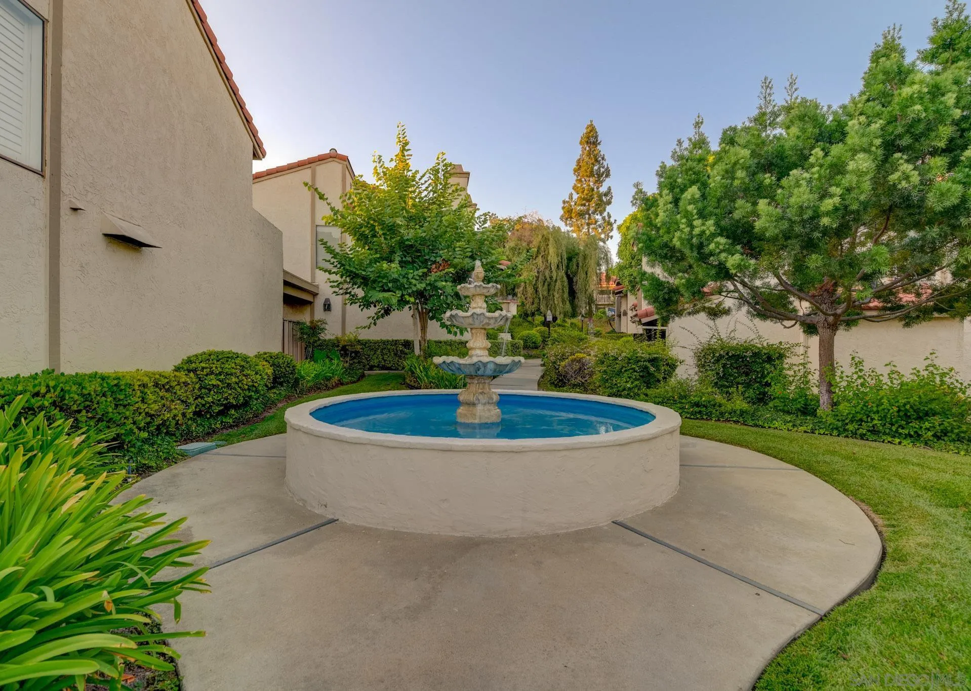 6877 Caminito Mundo, Unit 25 San Diego, CA 92119 - Photo 26 of 28 a view of a fountain in the middle of a garden
