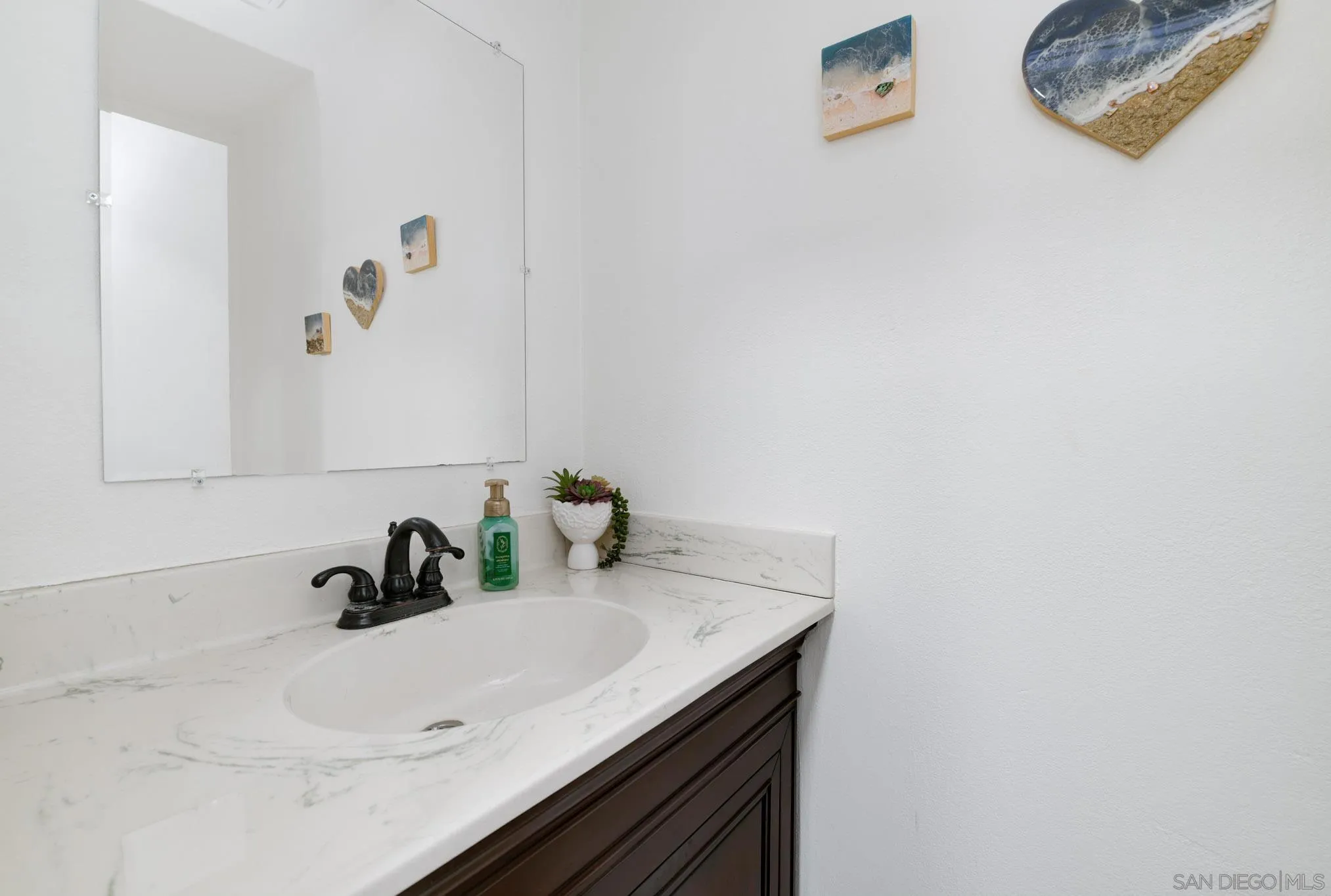 6877 Caminito Mundo, Unit 25 San Diego, CA 92119 - Photo 5 of 28 a bathroom with a sink and a mirror