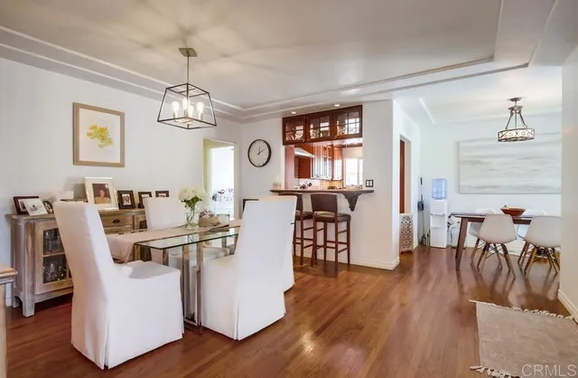 a view of a dining room with furniture wooden floor and chandelier