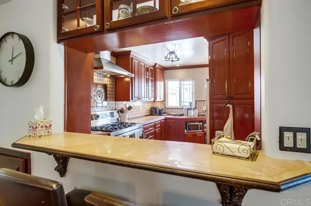 a view of a kitchen counter space a sink and appliances