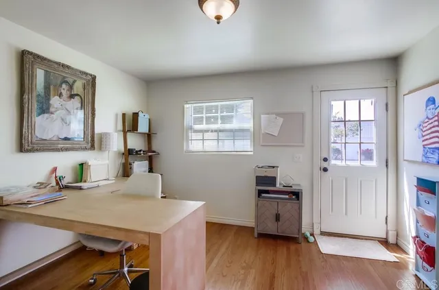 a kitchen with a sink cabinets and wooden floor