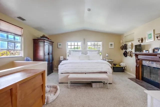 a bedroom with a bed dresser and a windows