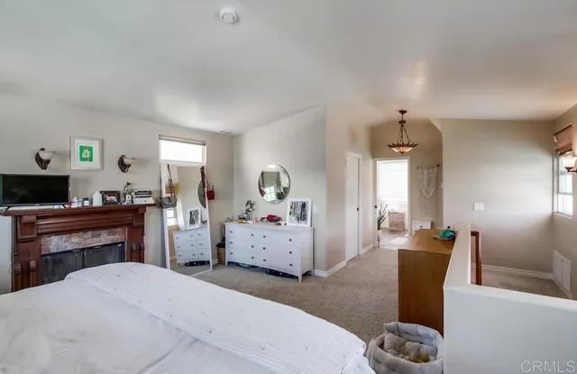 a bedroom with furniture and flat screen tv