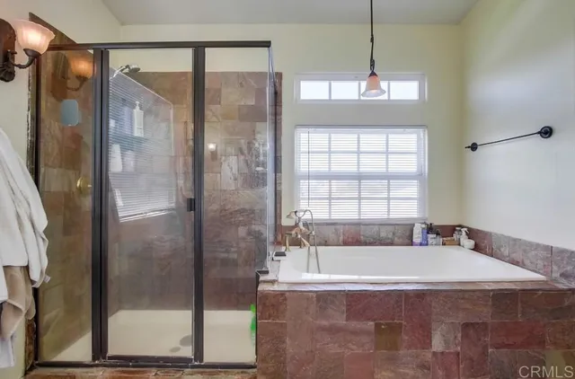 a bathroom with a tub shower and sink