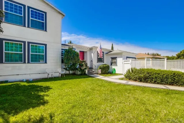 a front view of house with yard and green space