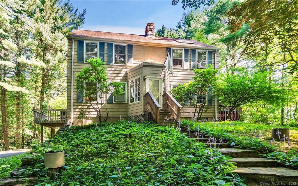37 Milan Road Woodbridge, CT 06525 - Photo 1 of 1 a front view of a house with a garden
