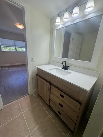 a bathroom with a sink a vanity and a mirror