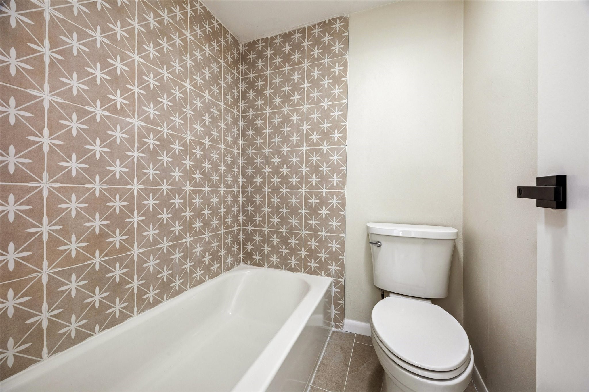 2100 Tanglewilde Street, Unit 195 Houston, TX 77063 - Photo 23 of 34 a white toilet sitting next to a shower curtain