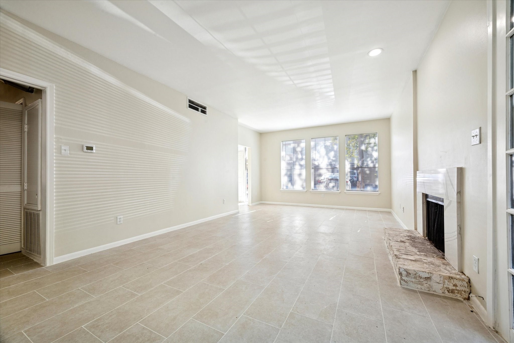 2100 Tanglewilde Street, Unit 195 Houston, TX 77063 - Photo 3 of 34 an empty room with windows fireplace and windows