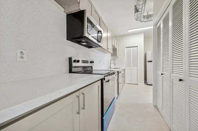 a kitchen with a sink and cabinets