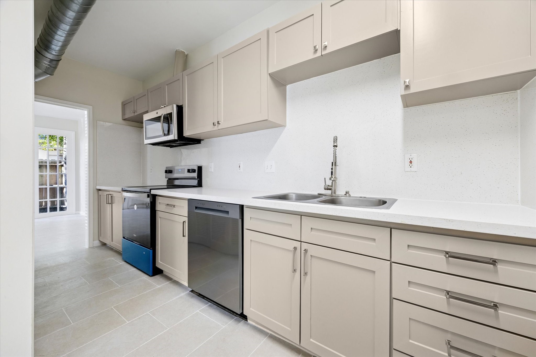 2100 Tanglewilde Street, Unit 195 Houston, TX 77063 - Photo 9 of 34 a kitchen with cabinets stainless steel appliances and sink