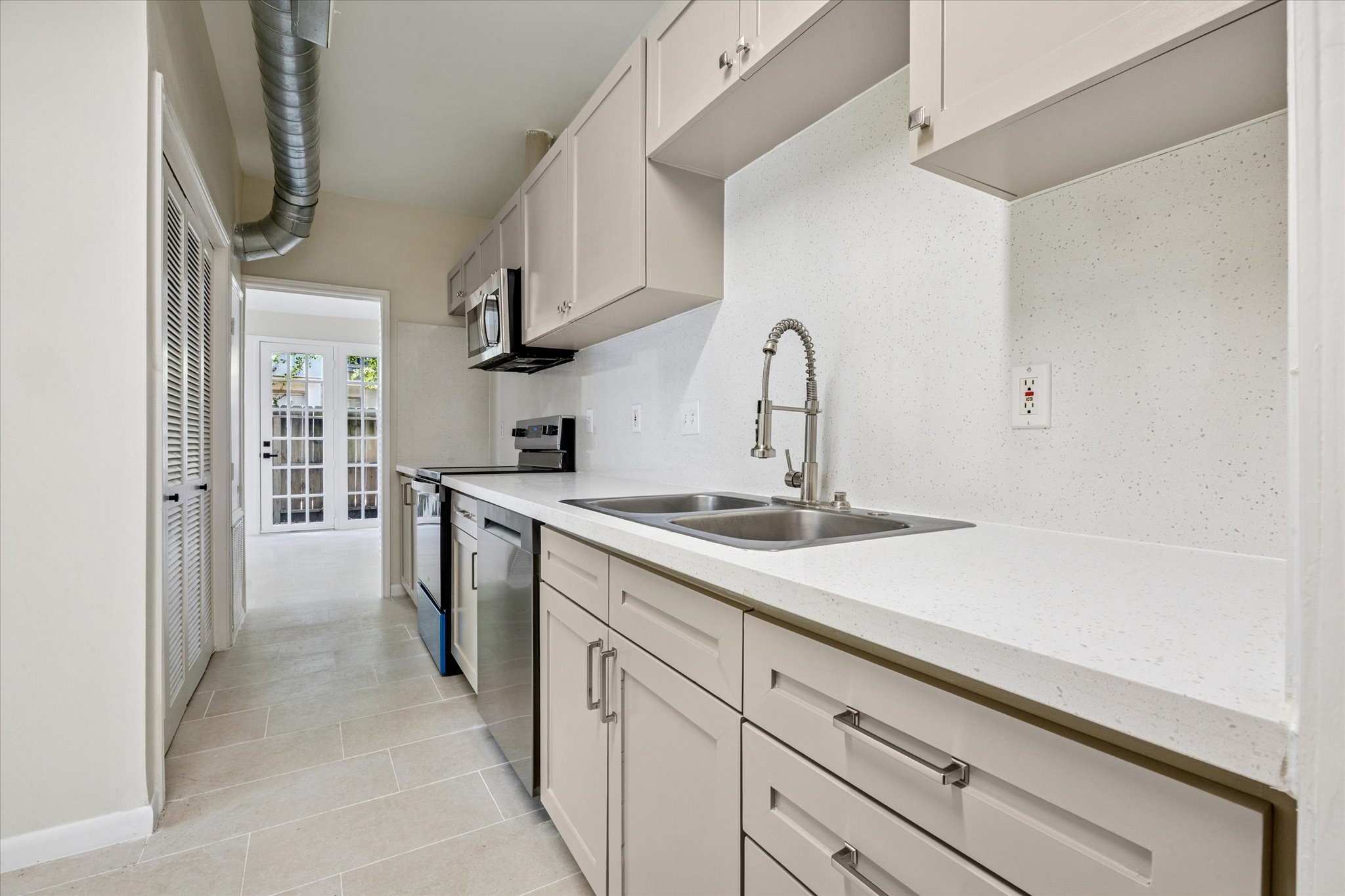 2100 Tanglewilde Street, Unit 195 Houston, TX 77063 - Photo 10 of 34 a kitchen with a sink and cabinets