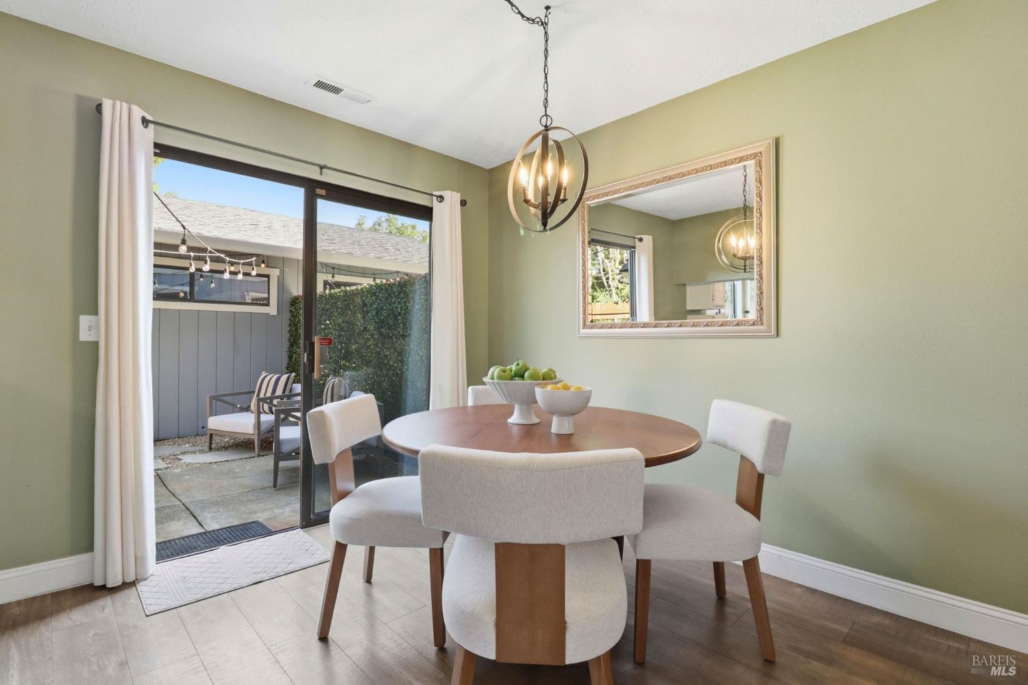 19167 Robinson Road, Unit H Sonoma, CA 95476 - Photo 11 of 32 a dining room with furniture a chandelier and wooden floor
