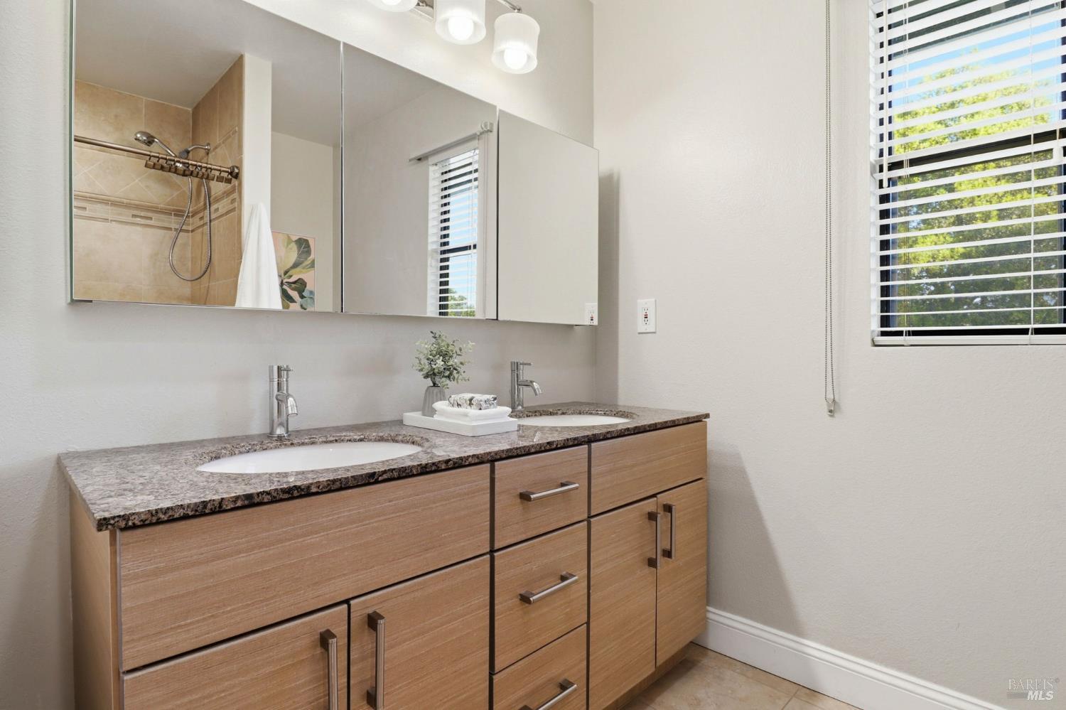 19167 Robinson Road, Unit H Sonoma, CA 95476 - Photo 21 of 32 a bathroom with a granite countertop sink and a mirror