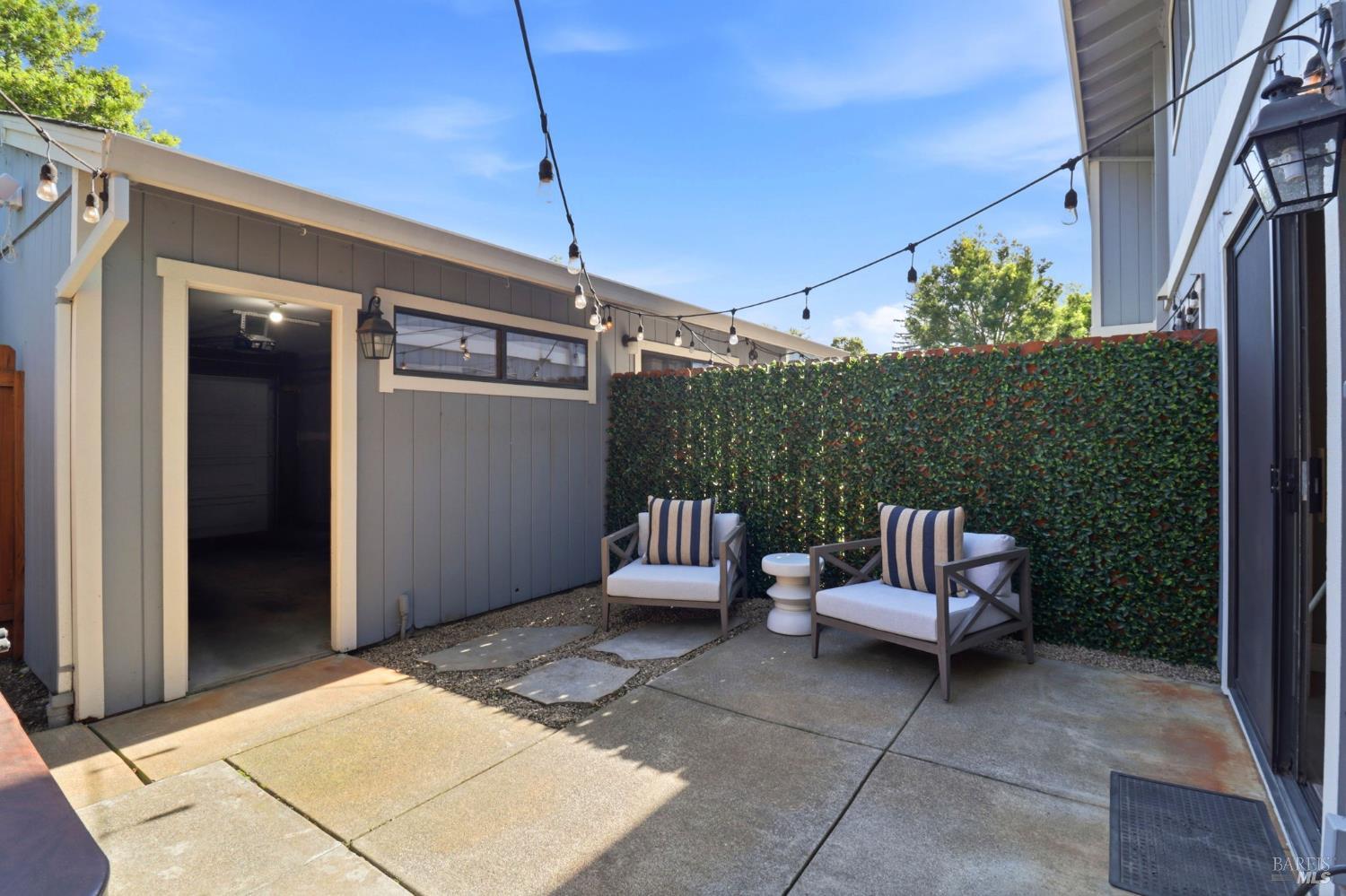 19167 Robinson Road, Unit H Sonoma, CA 95476 - Photo 30 of 32 a view of a patio with a dining table and chairs
