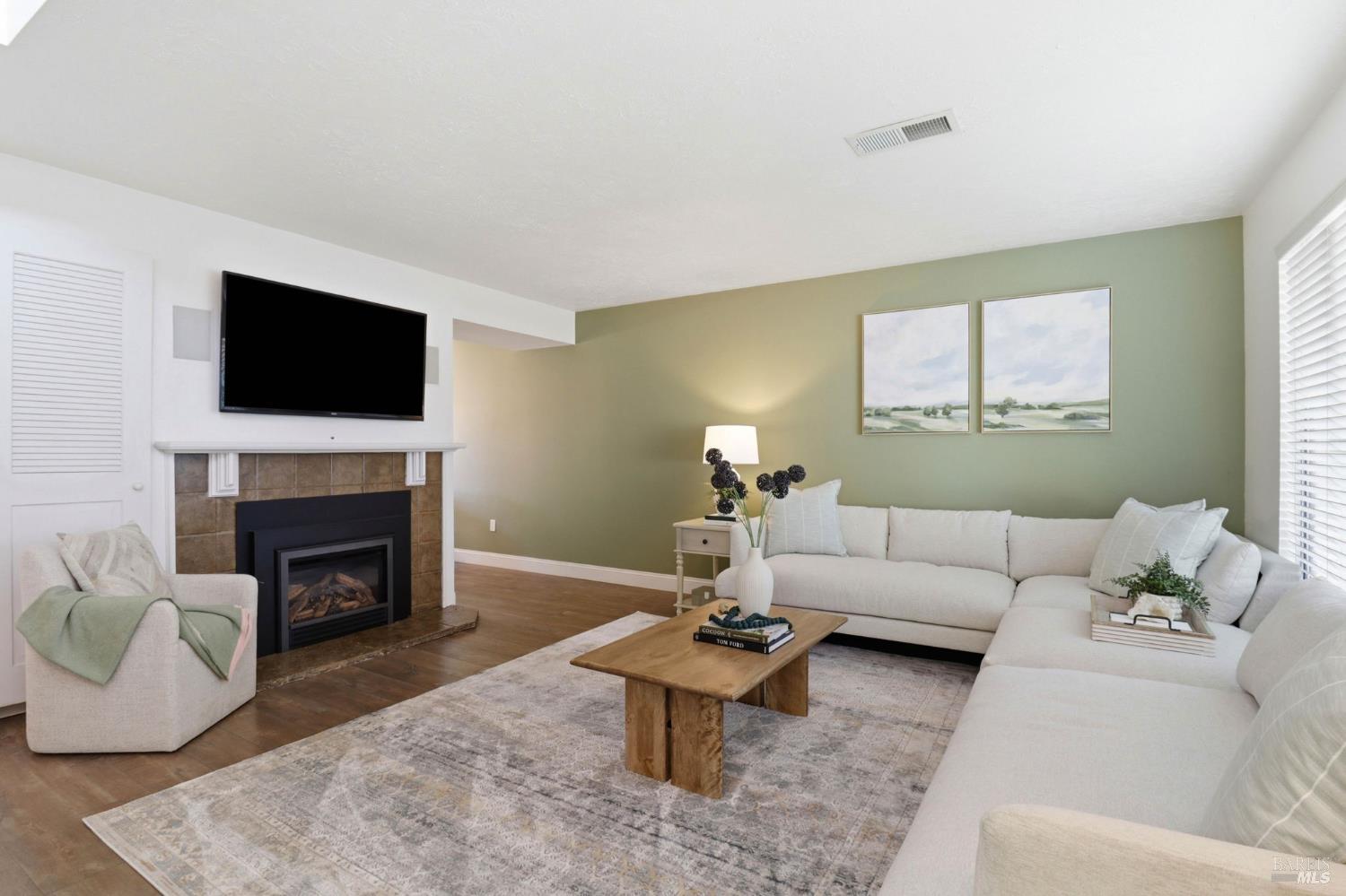 19167 Robinson Road, Unit H Sonoma, CA 95476 - Photo 3 of 32 a living room with furniture a fireplace and a flat screen tv