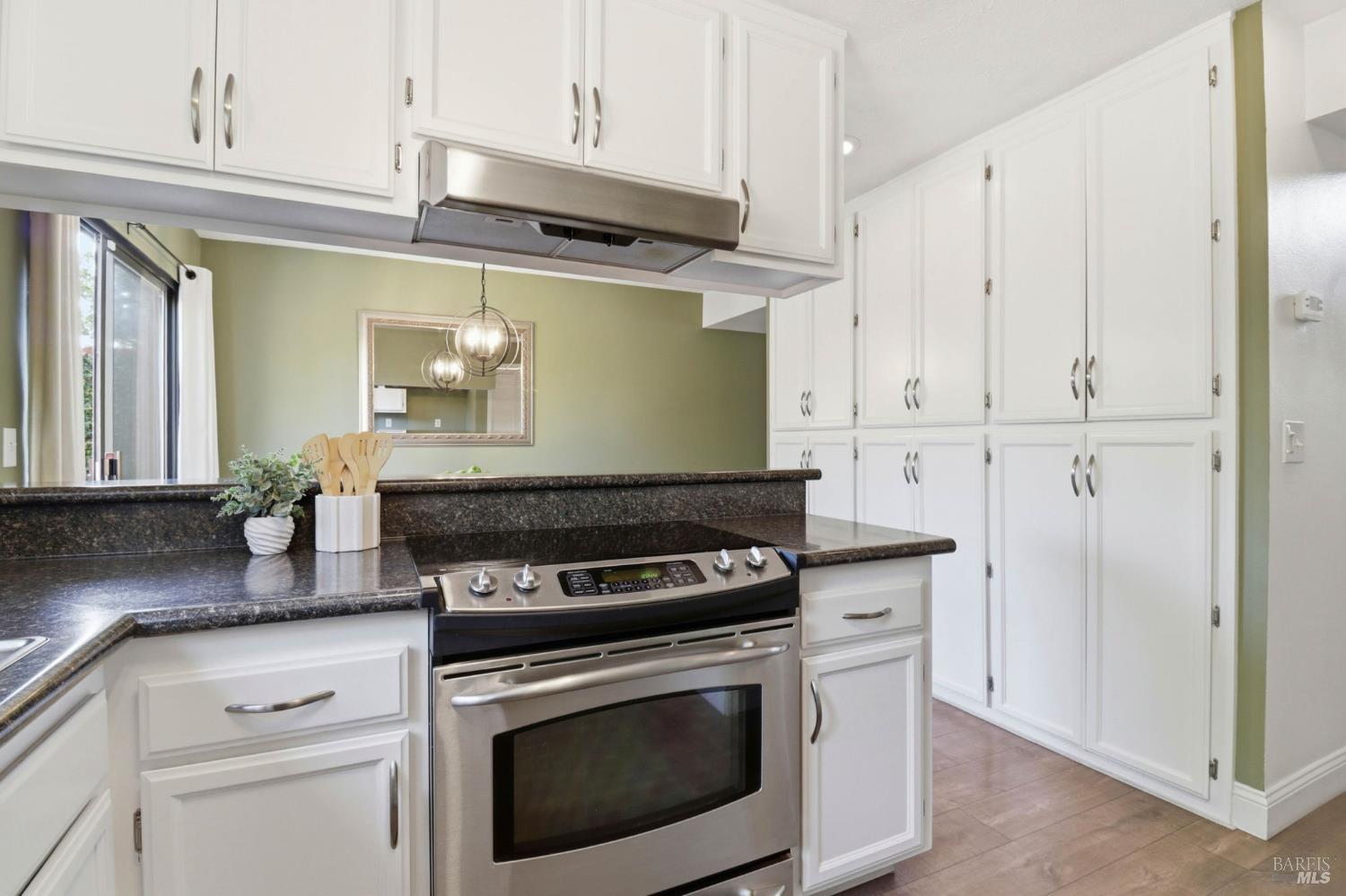 19167 Robinson Road, Unit H Sonoma, CA 95476 - Photo 6 of 32 a kitchen with granite countertop white cabinets and white appliances