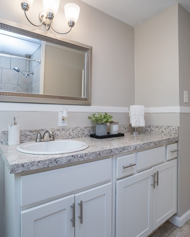 185 Pasco Road Springfield, MA 01151 - Photo 12 of 34 a bathroom with a granite countertop sink and a mirror