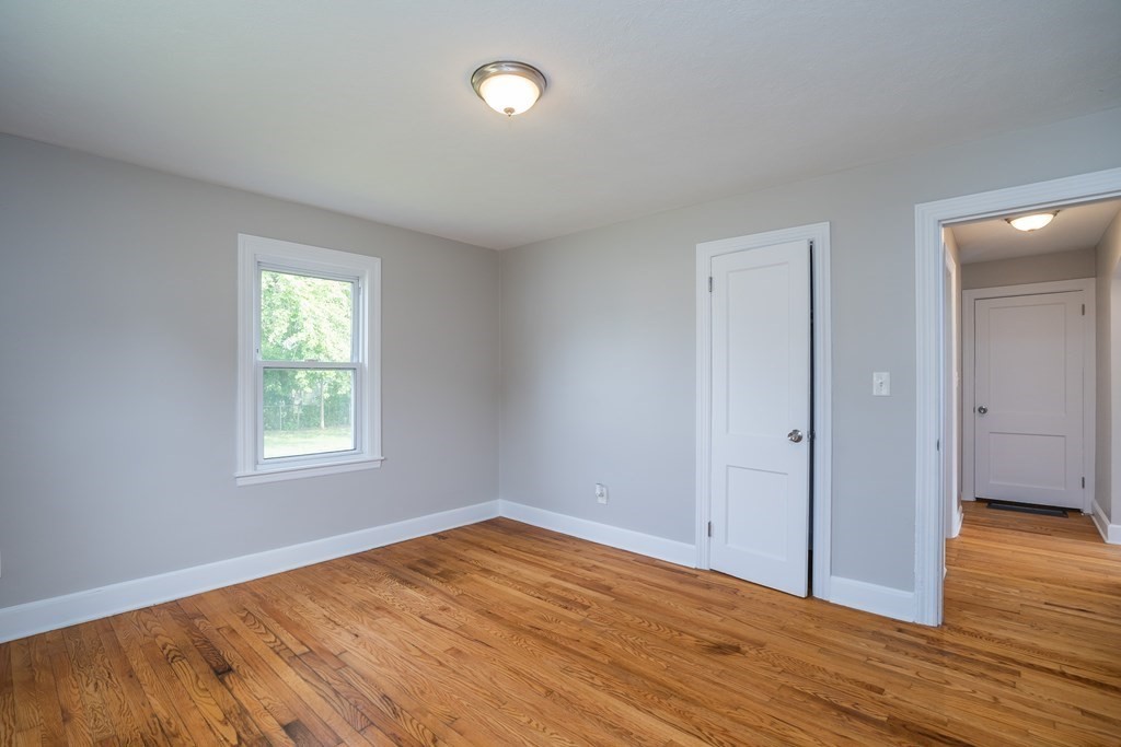 185 Pasco Road Springfield, MA 01151 - Photo 15 of 34 an empty room with wooden floor and windows