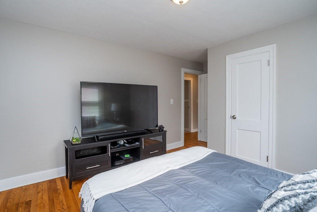 185 Pasco Road Springfield, MA 01151 - Photo 18 of 34 a bedroom with a bed and a flat screen tv
