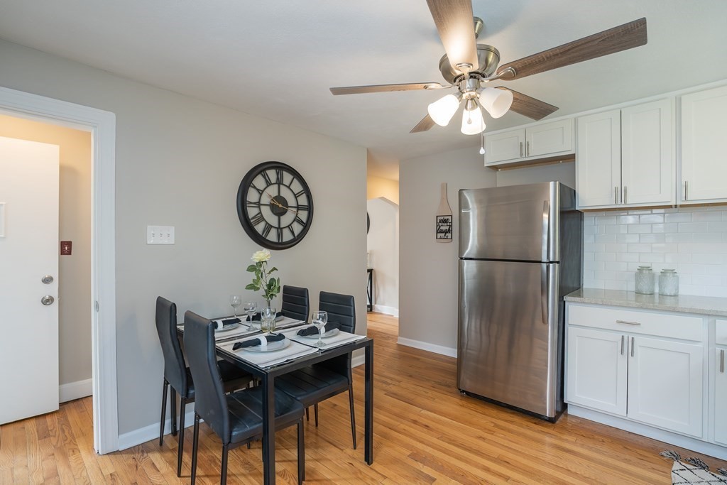 185 Pasco Road Springfield, MA 01151 - Photo 5 of 34 a kitchen with a refrigerator a dining table and chairs