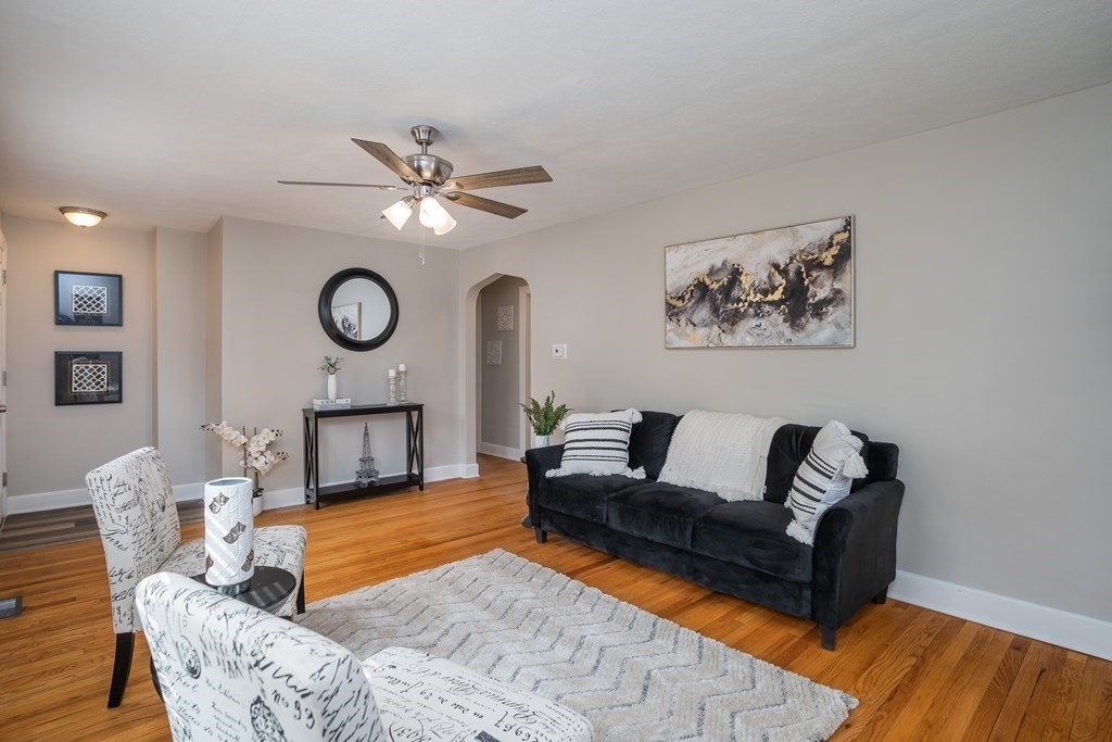 185 Pasco Road Springfield, MA 01151 - Photo 6 of 34 a living room with furniture a clock and a window